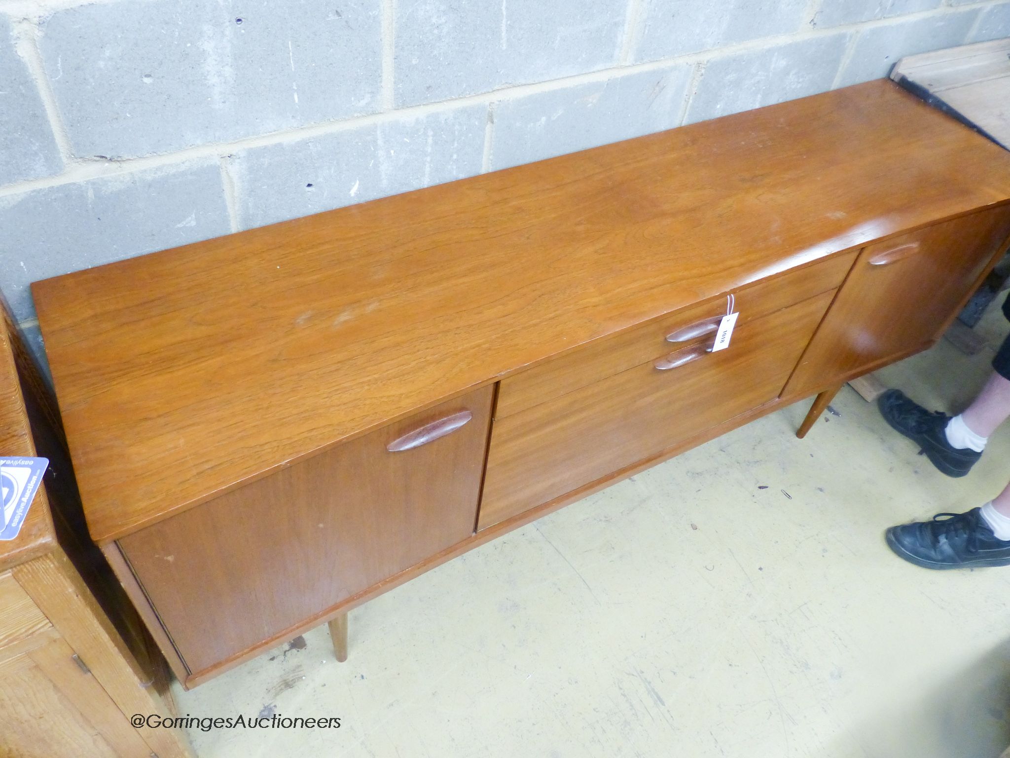 A mid century design teak sideboard, length 183cm, depth 46cm, height 76cm